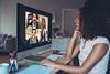 A young woman chats with colleagues in a virtual meeting
