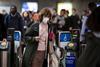 Woman wearing a medical mask travelling through underground station
