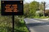 Traffic sign warning travellers to stay home during the coronavirus pandemic