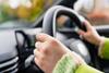 Close up shot of an anonymous driver at the wheel