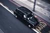 A London cab driving on a road
