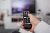 A remote control is pointed at a television