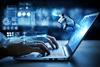 A robot's hand emerges from a laptop screen