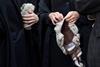 Barristers hold their wigs