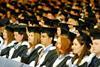 students sitting in graduation robes