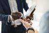 An estate agent hands house keys to a buyer