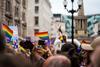 People waving rainbow flags during Gay Pride parade
