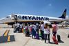 Ryanair passengers queue to board the plane