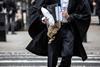 A barrister holds his wig on his way to court
