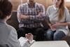 An anonymous couple sit with their lawyer