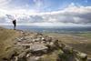 A hiker admires the view from the top of Ingleborough, one of the Three Peaks in the Yorkshire Dales National Park, North Yorkshire