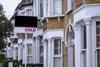 Sold sign outside row of terraced houses