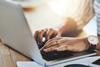 Woman typing on laptop