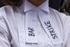The words 'Bar strike' are written on a barrister's shirt