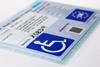Blue badge card with wheelchair symbol for disabled parking concessions scheme