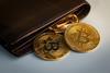Bitcoin coins spilling out of wallet