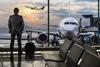 Business man stood at airport gate waiting to board plane