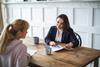A solicitor talks through a document with her young client