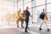 Blurred office workers walking into building