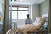Anonymous woman sits on a hospital bed