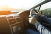 An anonymous man driving a car