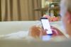 A woman on her phone in the bath