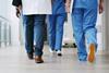 Hospital staff walk down the corridor