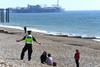 Police officer asks people to leave the beach in Brighton during Covid-19 outbreak