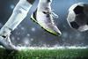 Close up of footballer kicking the ball
