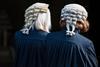 Two barristers wearing wigs and robes