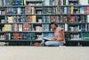 Student in library reading a book