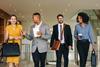Colleagues walk through the office together