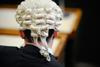 A man wears a barrister wig