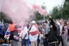 Rioters hold a flare during a riot outside of the Holiday Inn Express in Rotherham