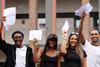 Students hold their A-level results