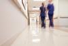 Blurred image of medical staff walking down hospital corridor