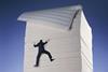 Businessman climbing paper