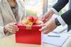 Office worker giving colleague a present