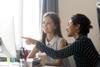 Two young women working together in an office