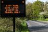 Traffic sign warning travellers to stay home during the coronavirus pandemic