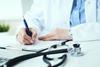 A doctor writing up a patient's medical records
