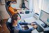 Two women working in office with protective masks - coronavirus