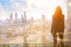 A City worker looks out over the City of London skyline