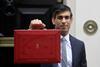 Chancellor Rishi Sunak stands with his red briefcase in front of 11 Downing Street