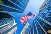 US flag amongst city skyscrapers