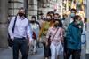 Masked London commuters make their way to work during the coronavirus