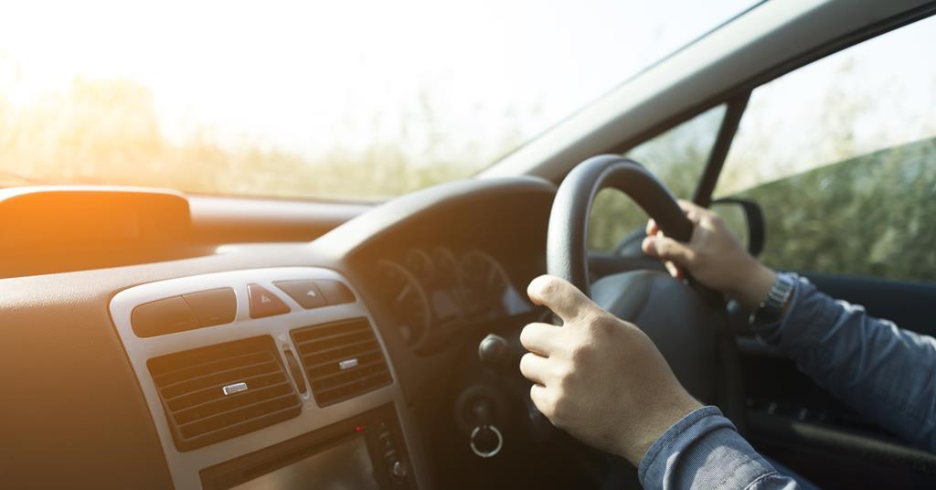 An anonymous man driving a car
