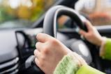 Close up shot of an anonymous driver at the wheel