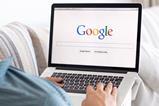 Man uses Google on laptop