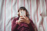 Child scrolling on social media on phone
